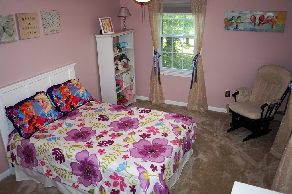 6 Pinewood Road Chelmsford, MA 01824 - Photo 18 of 27 a bedroom with a bed and a chair in it