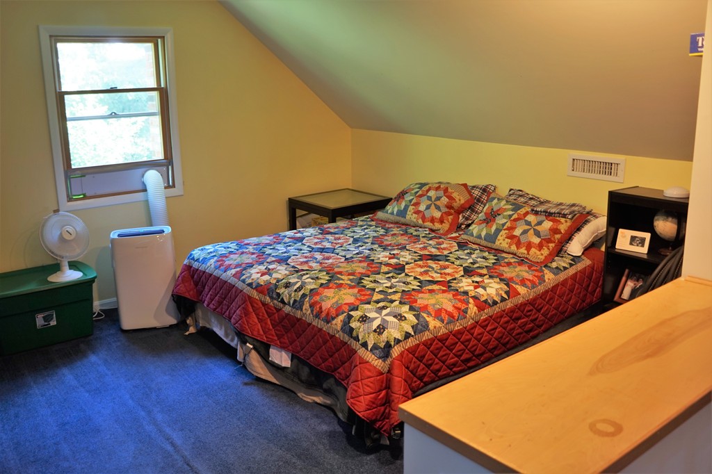 6 Pinewood Road Chelmsford, MA 01824 - Photo 23 of 27 a bed sitting in a bedroom next to a window