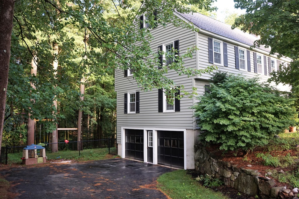 6 Pinewood Road Chelmsford, MA 01824 - Photo 25 of 27 a front view of a house with a garden