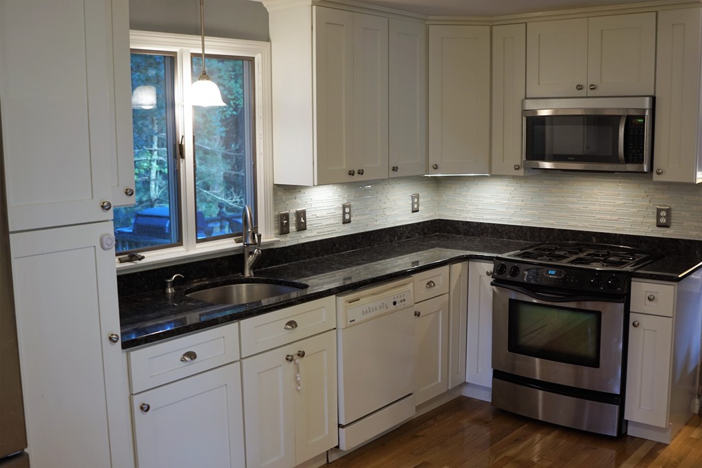 6 Pinewood Road Chelmsford, MA 01824 - Photo 3 of 27 a kitchen with granite countertop white cabinets stainless steel appliances and a sink