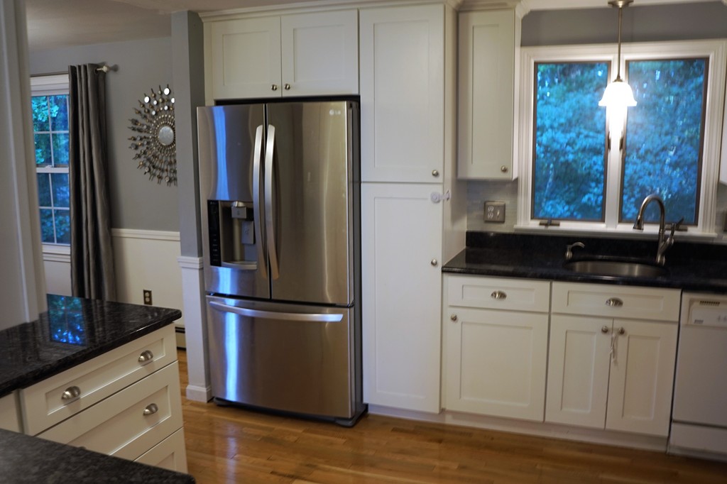 6 Pinewood Road Chelmsford, MA 01824 - Photo 4 of 27 a kitchen with a refrigerator and cabinets