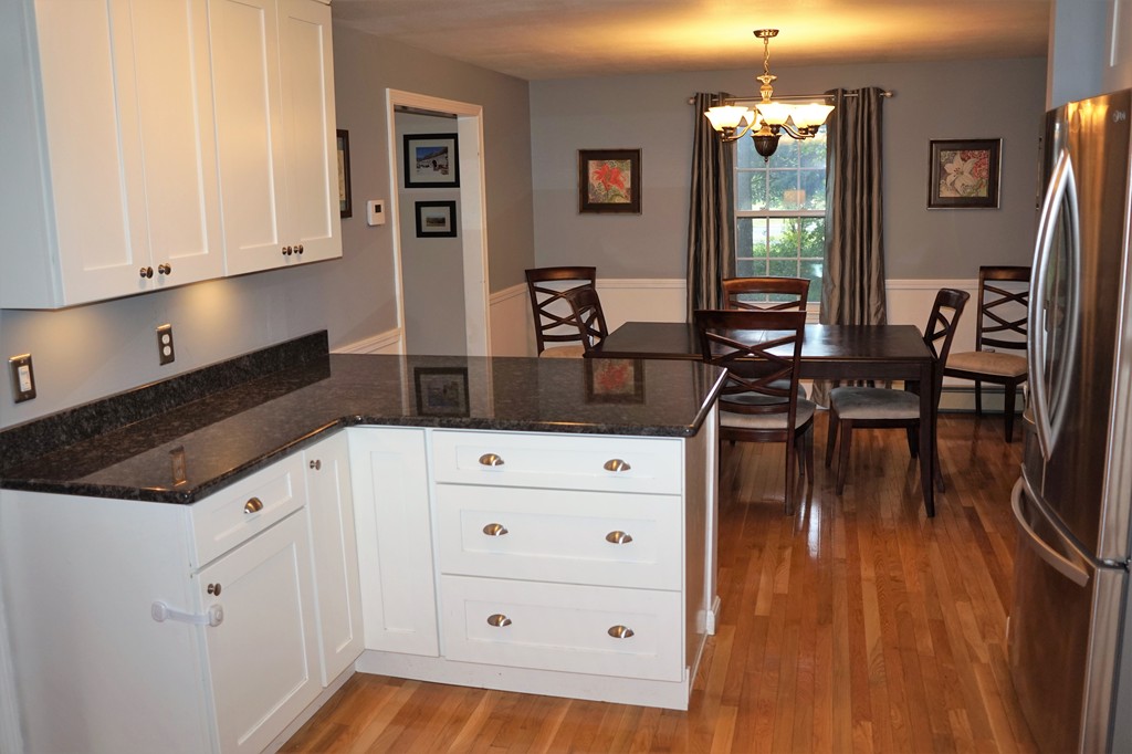 6 Pinewood Road Chelmsford, MA 01824 - Photo 6 of 27 a kitchen with cabinets appliances and a wooden floor