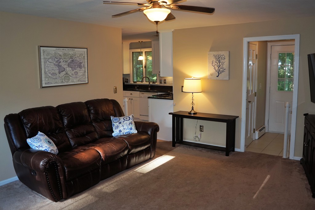 6 Pinewood Road Chelmsford, MA 01824 - Photo 9 of 27 a living room with furniture and a chandelier