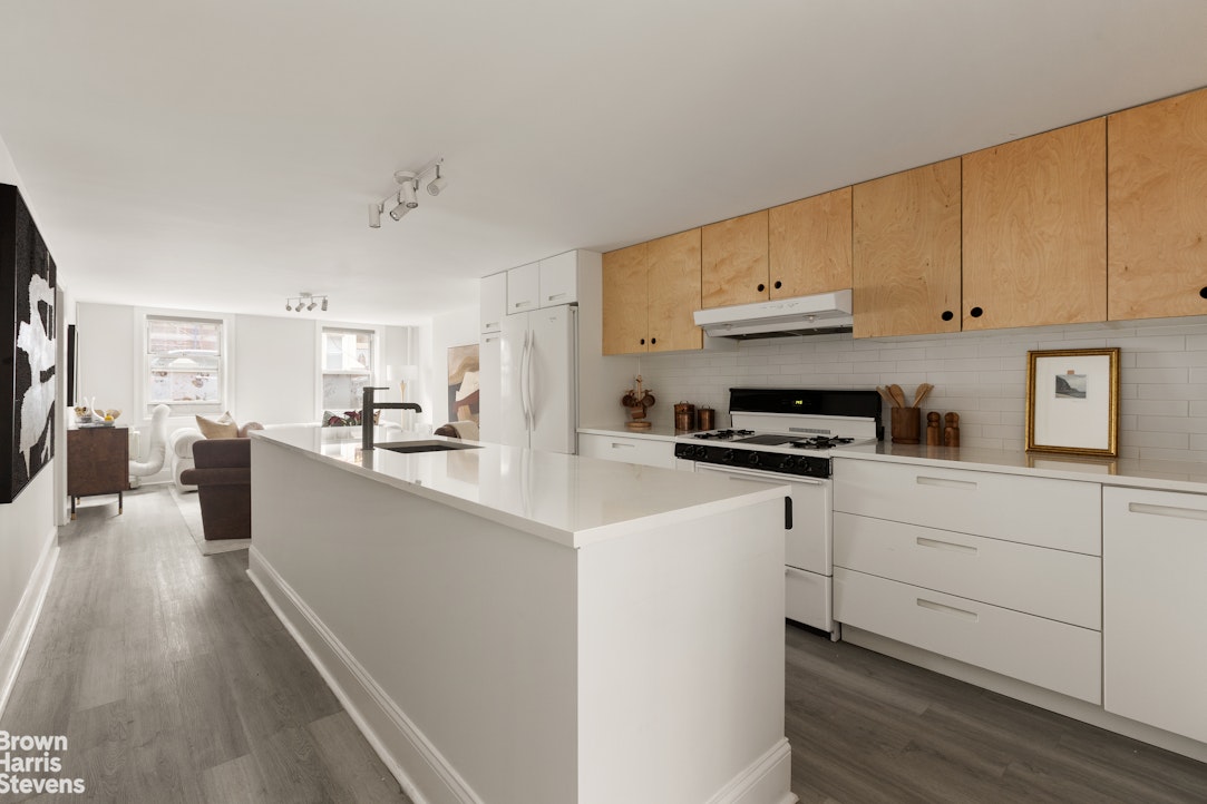 91 Berry Street Brooklyn, NY 11249 - Photo 10 of 14 a kitchen with cabinets wooden floor and a counter top space