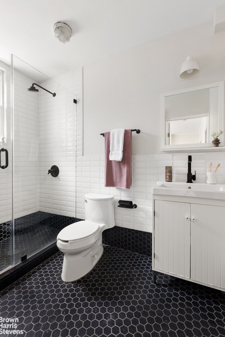 91 Berry Street Brooklyn, NY 11249 - Photo 12 of 14 a bathroom with a sink toilet a mirror and shower