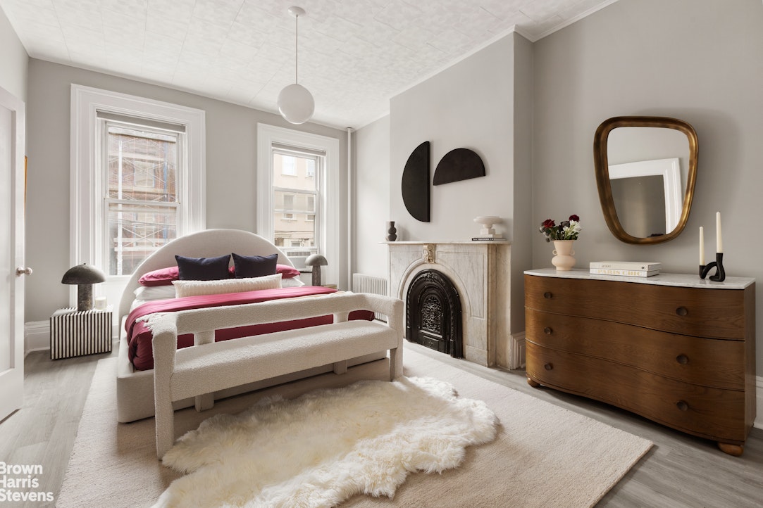 91 Berry Street Brooklyn, NY 11249 - Photo 2 of 14 a bedroom with a bed a mirror and window