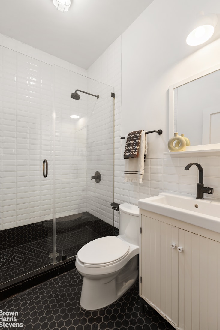 91 Berry Street Brooklyn, NY 11249 - Photo 6 of 14 a bathroom with a sink toilet and shower