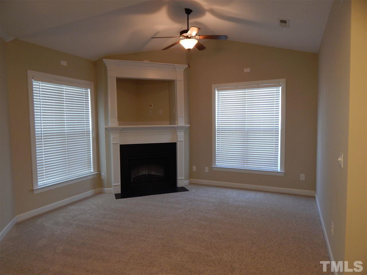 3513 Provost Street Raleigh, NC 27603 - Photo 8 of 25 Electric fireplace with built in TV nook and vaulted ceiling