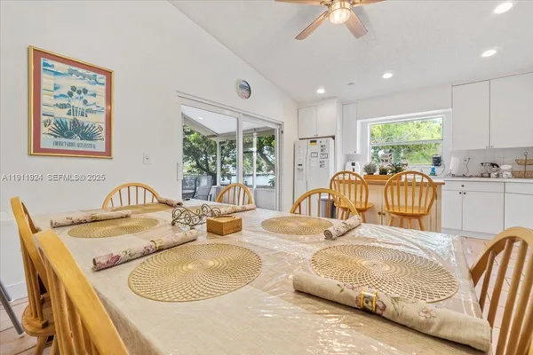 a view of a dining room with furniture a chandelier and window