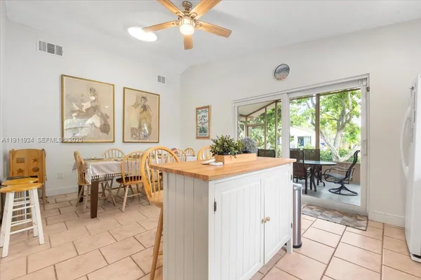 a living room with furniture a dining table and a large window