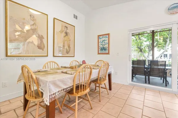 a view of a dining room with furniture and a large window