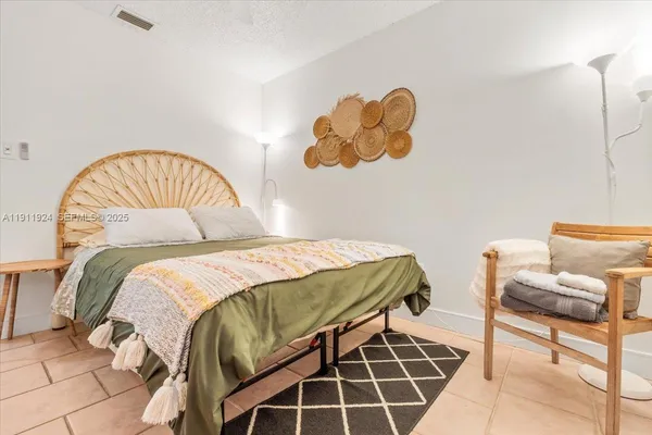 a bedroom with a bed and a chair