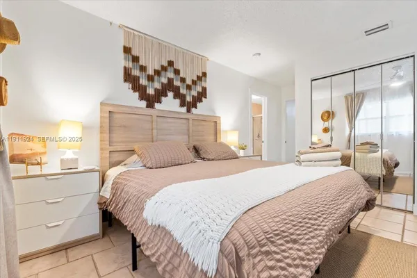 a bedroom with a large bed and a window