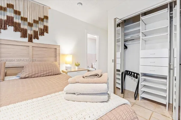 a bedroom with a bed and a mirror