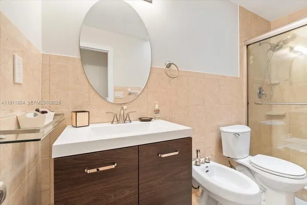a white toilet sitting next to a bathroom sink