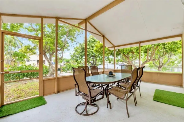 a dining room with furniture a window and wooden floor