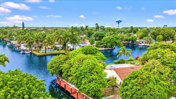 an aerial view of residential houses with outdoor space and swimming pool