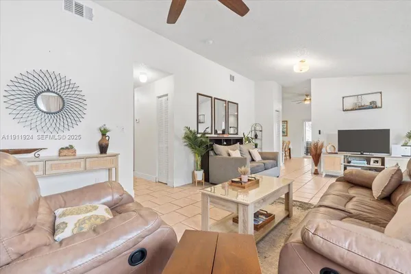 a living room with furniture and a flat screen tv