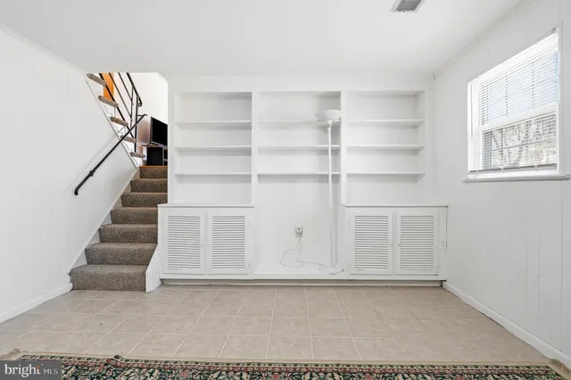 a view of an empty room with stairs