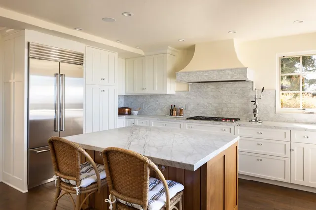 a kitchen with granite countertop a sink cabinets and window