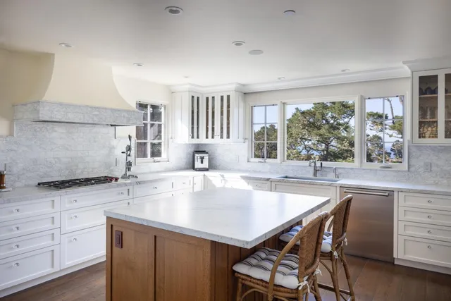 a kitchen with a stove a sink and a refrigerator