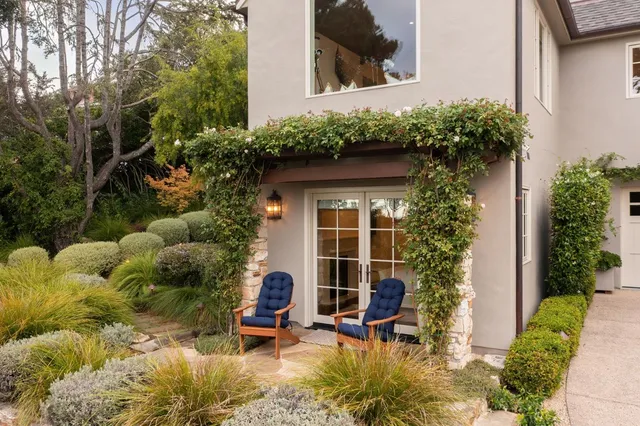 a view of a chair and table in backyard of the house
