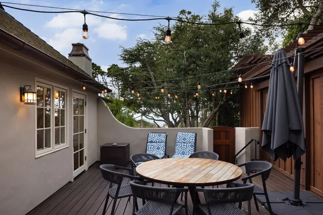a backyard of a house with table and chairs
