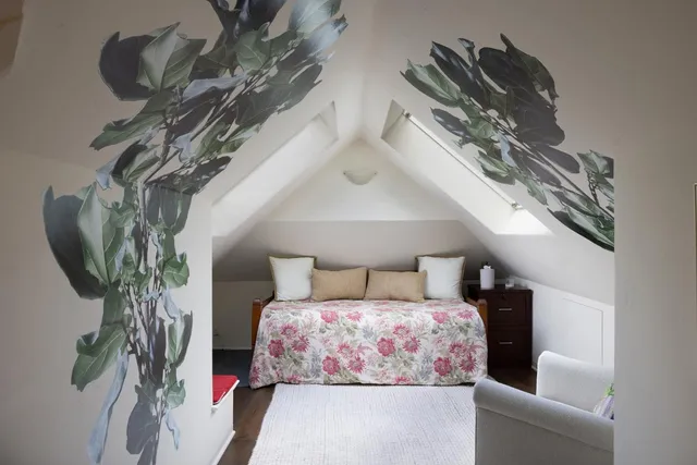a bedroom with a bed and a potted plant