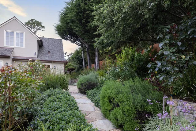 a view of a house with a yard and garden