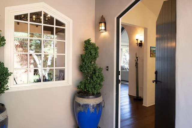 hallway with wooden floor and a potted plant