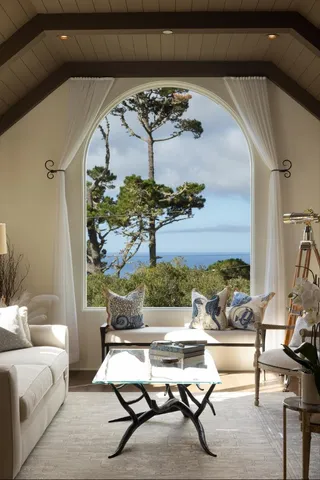 a living room with furniture and flowers