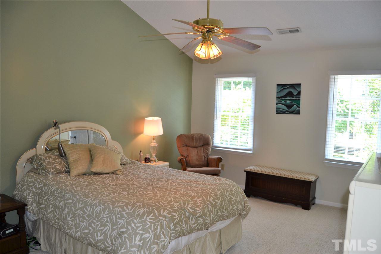 3537 Dechart Lane Raleigh, NC 27616 - Photo 10 of 21 a bedroom with a bed and a chandelier