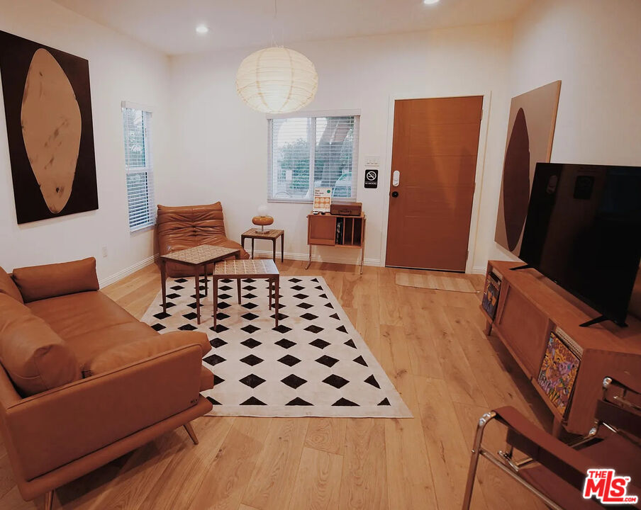 3318 Merced Street Los Angeles, CA 90065 - Photo 3 of 9 a bedroom with furniture and a flat screen tv