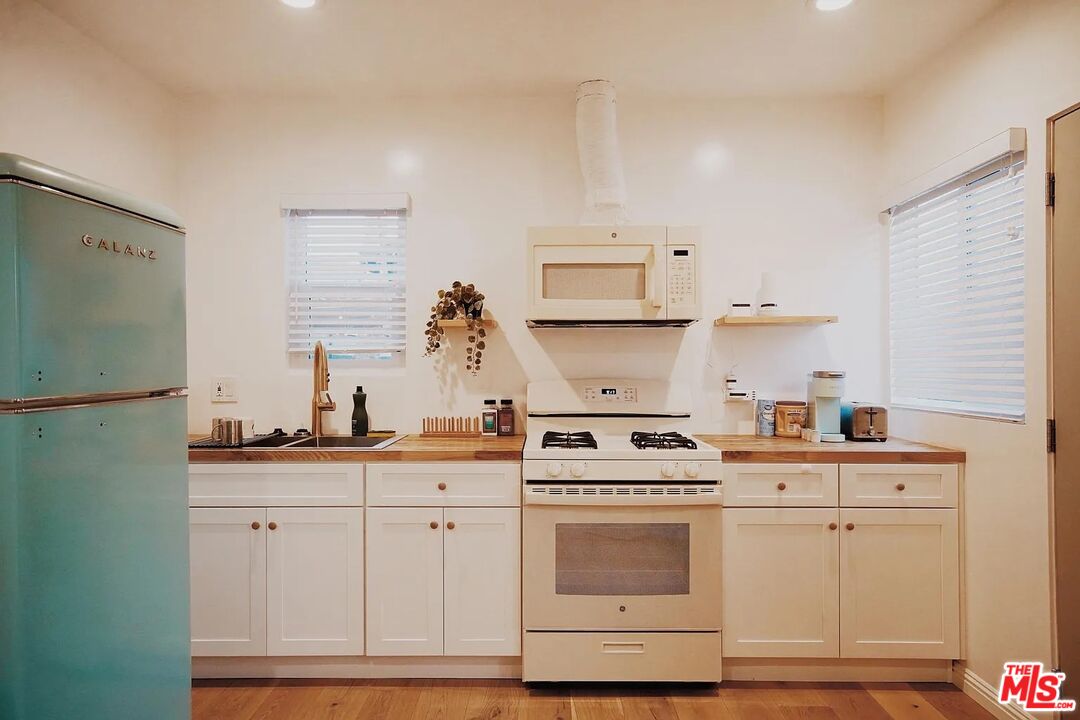 3318 Merced Street Los Angeles, CA 90065 - Photo 5 of 9 a kitchen with cabinets and white appliances
