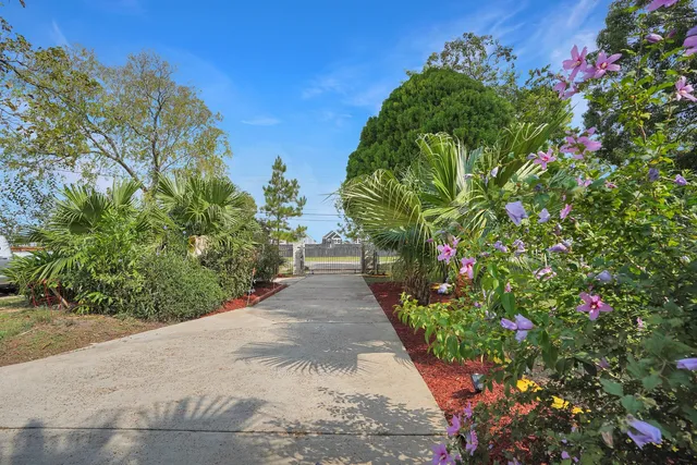 a view of a house with a yard and sitting area