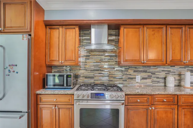 a kitchen with stainless steel appliances granite countertop a stove a sink and a microwave
