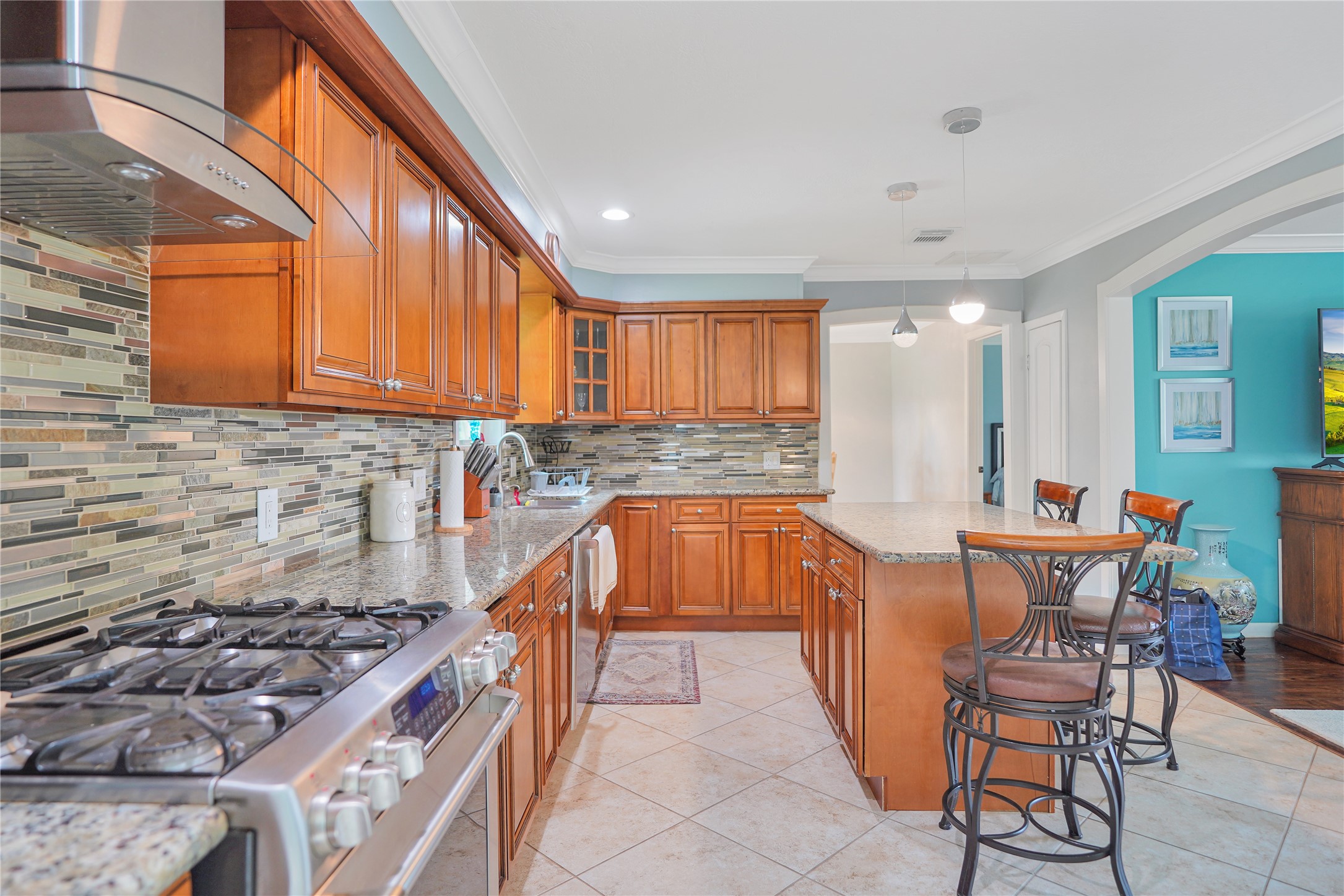 4920 Almeda Genoa Road Houston, TX 77048 - Photo 10 of 29 a kitchen with stainless steel appliances granite countertop a stove a sink and a microwave
