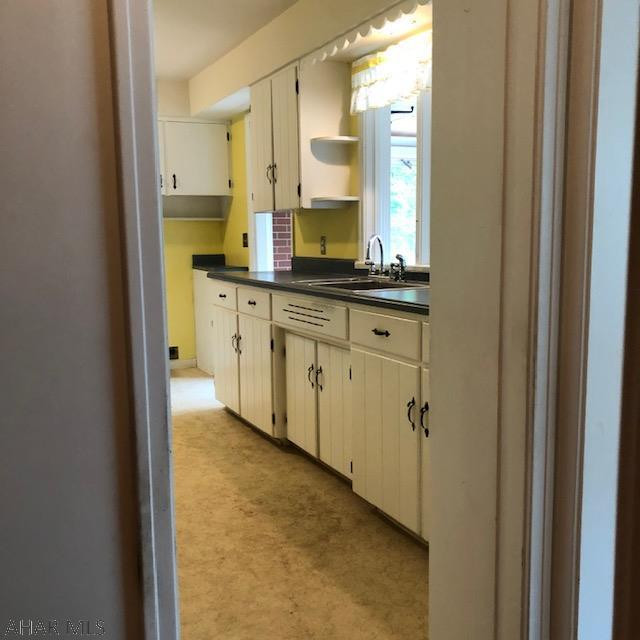 525 Egolf Road Bedford, PA 15522 - Photo 17 of 61 a bathroom with a granite countertop sink and a mirror