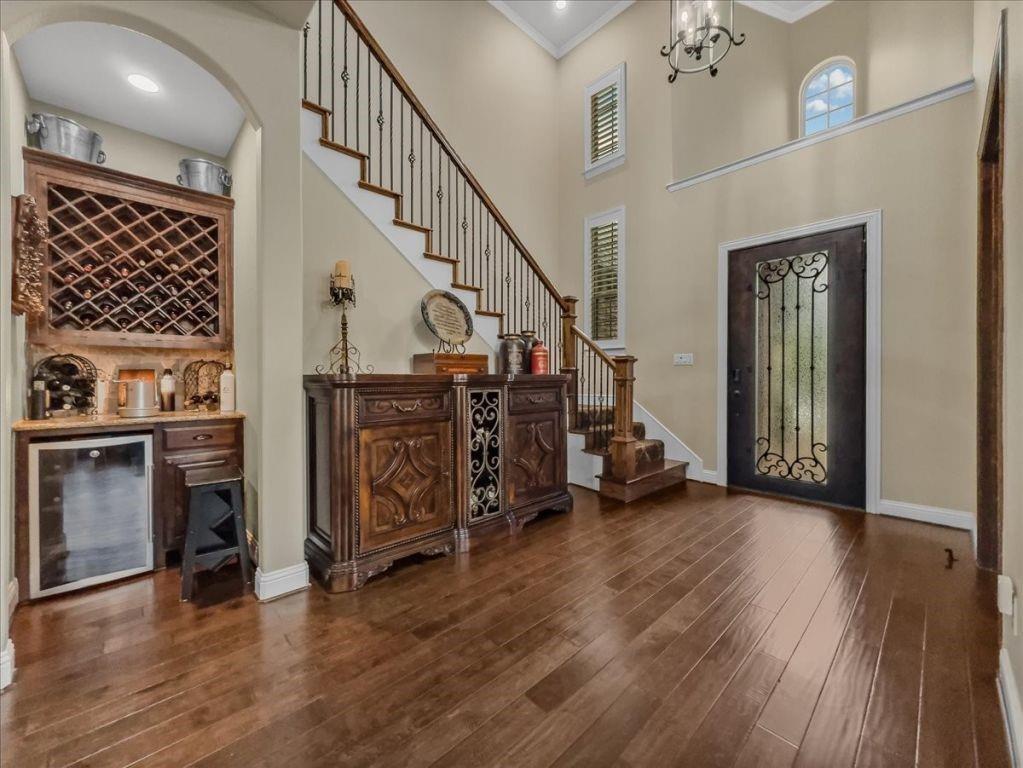 2832 Mona Vale Road Trophy Club, TX 76262 - Photo 3 of 37 a view of a hallway with stairs to livingroom with wooden floor