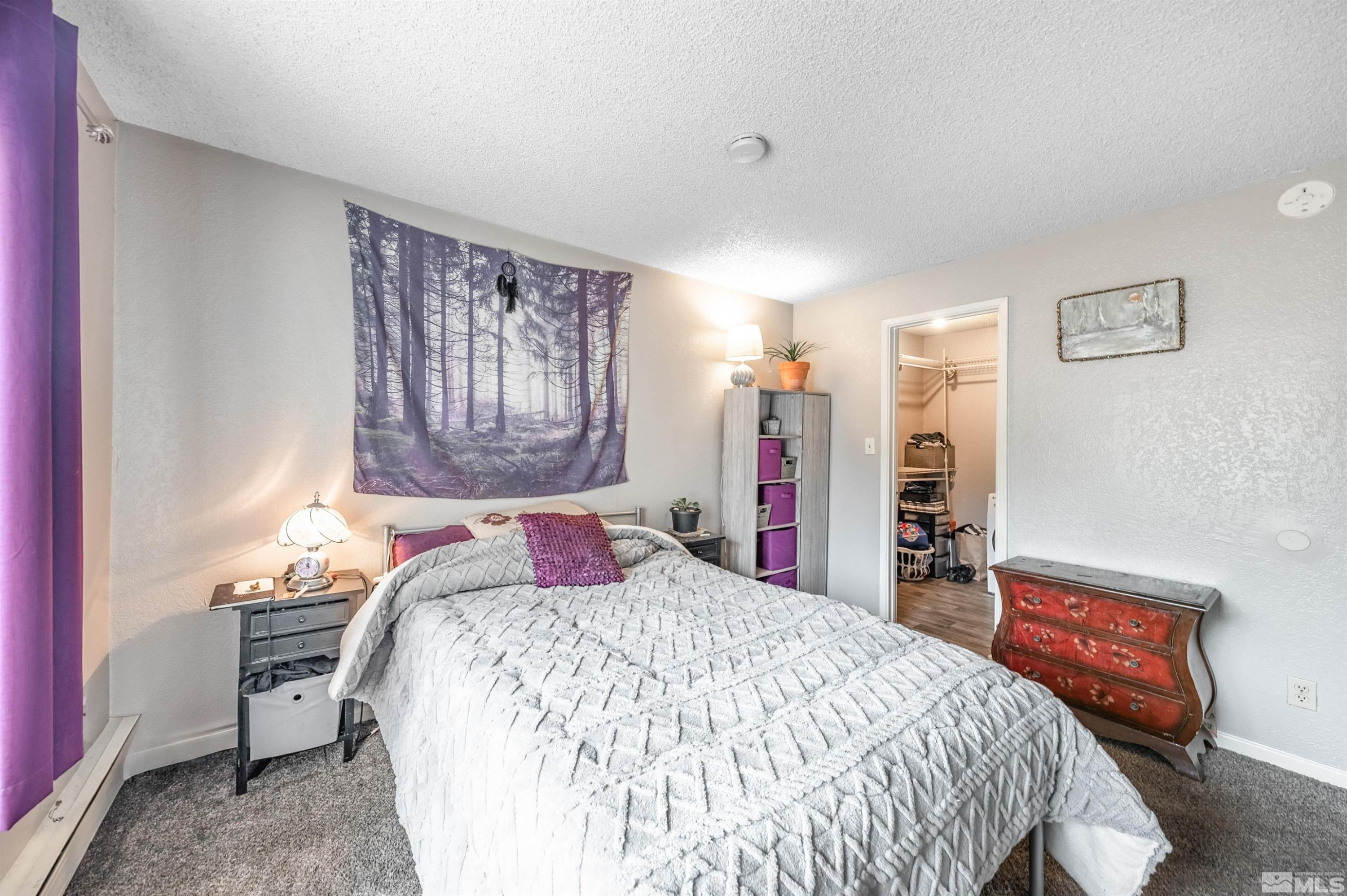 3951 Clear Acre Lane, Unit 296 Reno, NV 89512 - Photo 11 of 20 a bed sitting in a bedroom next to a window