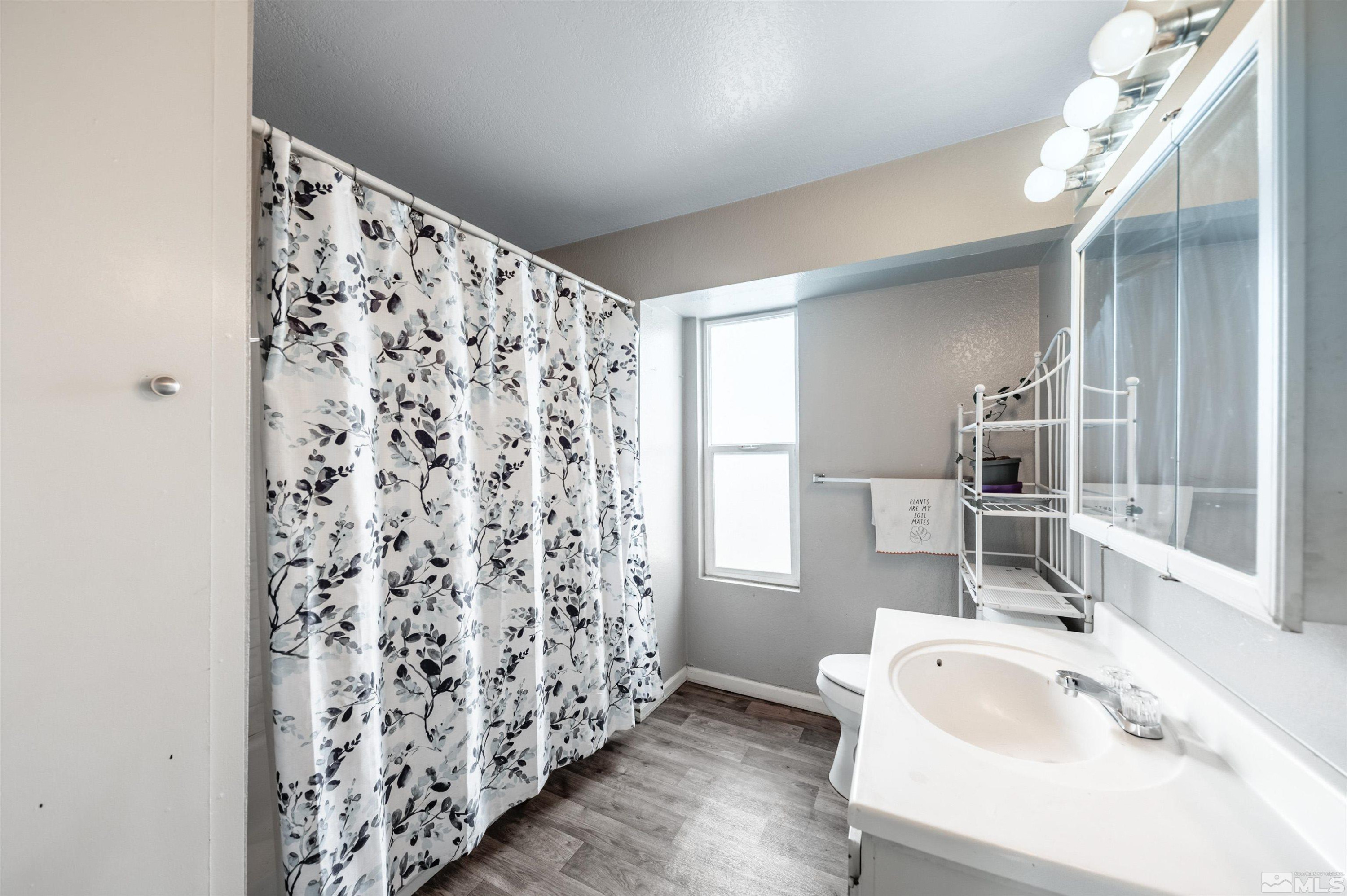 3951 Clear Acre Lane, Unit 296 Reno, NV 89512 - Photo 13 of 20 a bathroom with a sink toilet and shower