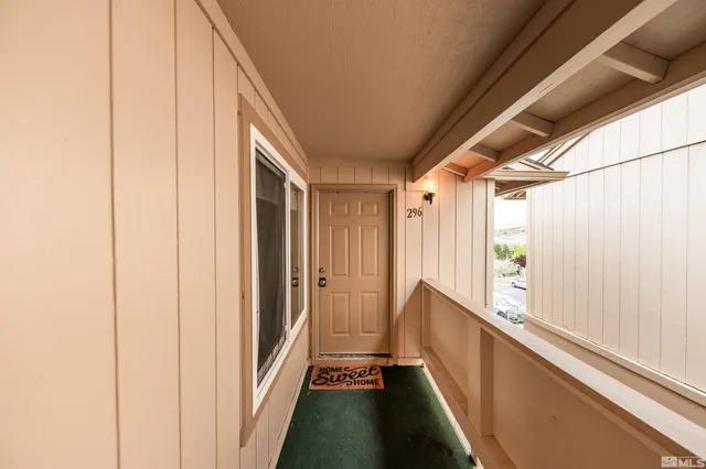 a view of hallway with wooden floor