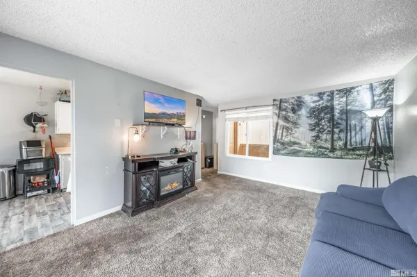 a living room with furniture a large window and a flat screen tv