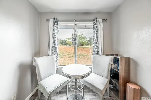 a view of a room with a table and chairs