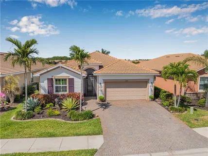 a front view of a house with a yard and a garage