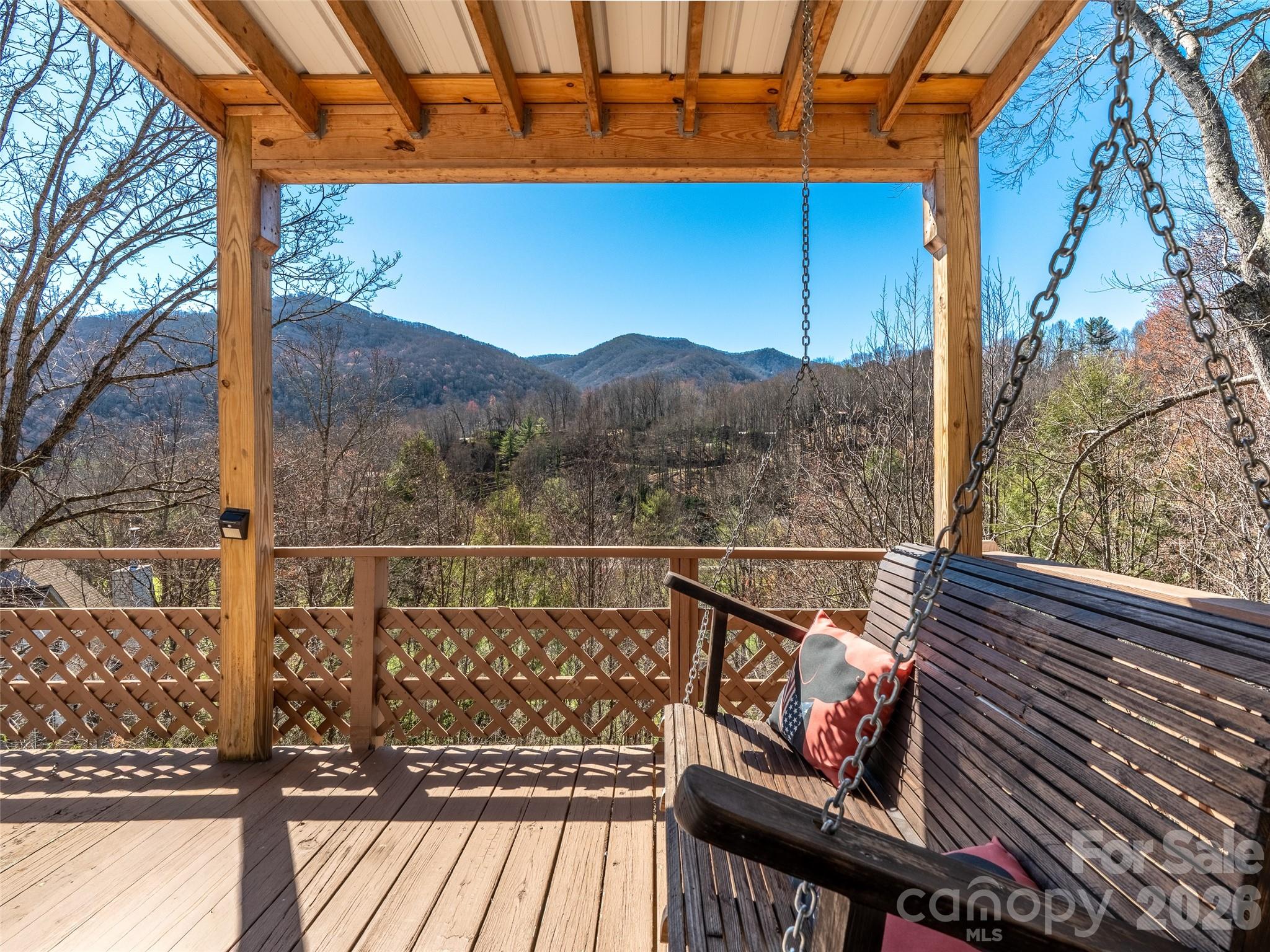 174 Pleasant Ridge Drive Maggie Valley, NC 28751 - Photo 12 of 45 a view of a balcony with wooden floor and outdoor seating