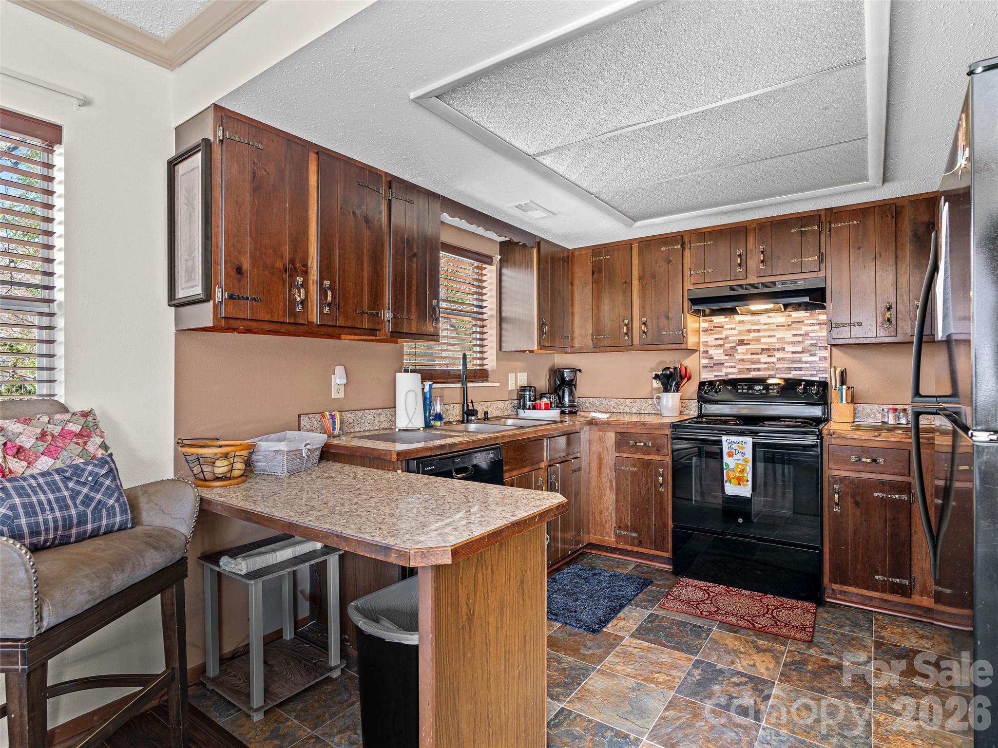 174 Pleasant Ridge Drive Maggie Valley, NC 28751 - Photo 15 of 45 a kitchen with a stove refrigerator and cabinets