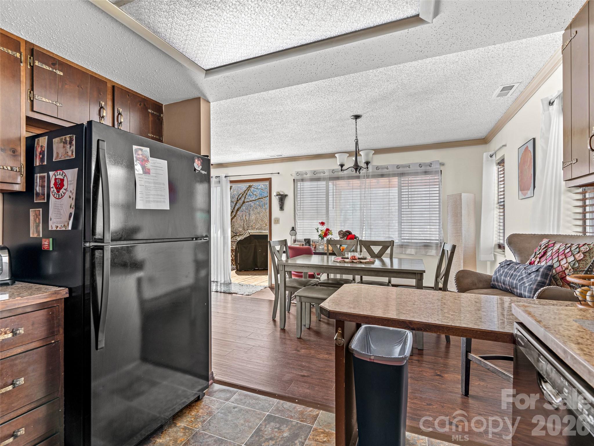 174 Pleasant Ridge Drive Maggie Valley, NC 28751 - Photo 18 of 45 a kitchen with stainless steel appliances granite countertop a stove refrigerator and cabinets