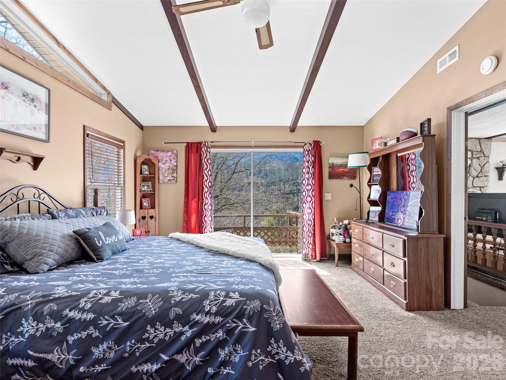 174 Pleasant Ridge Drive Maggie Valley, NC 28751 - Photo 22 of 45 a bedroom with a large bed and a large window