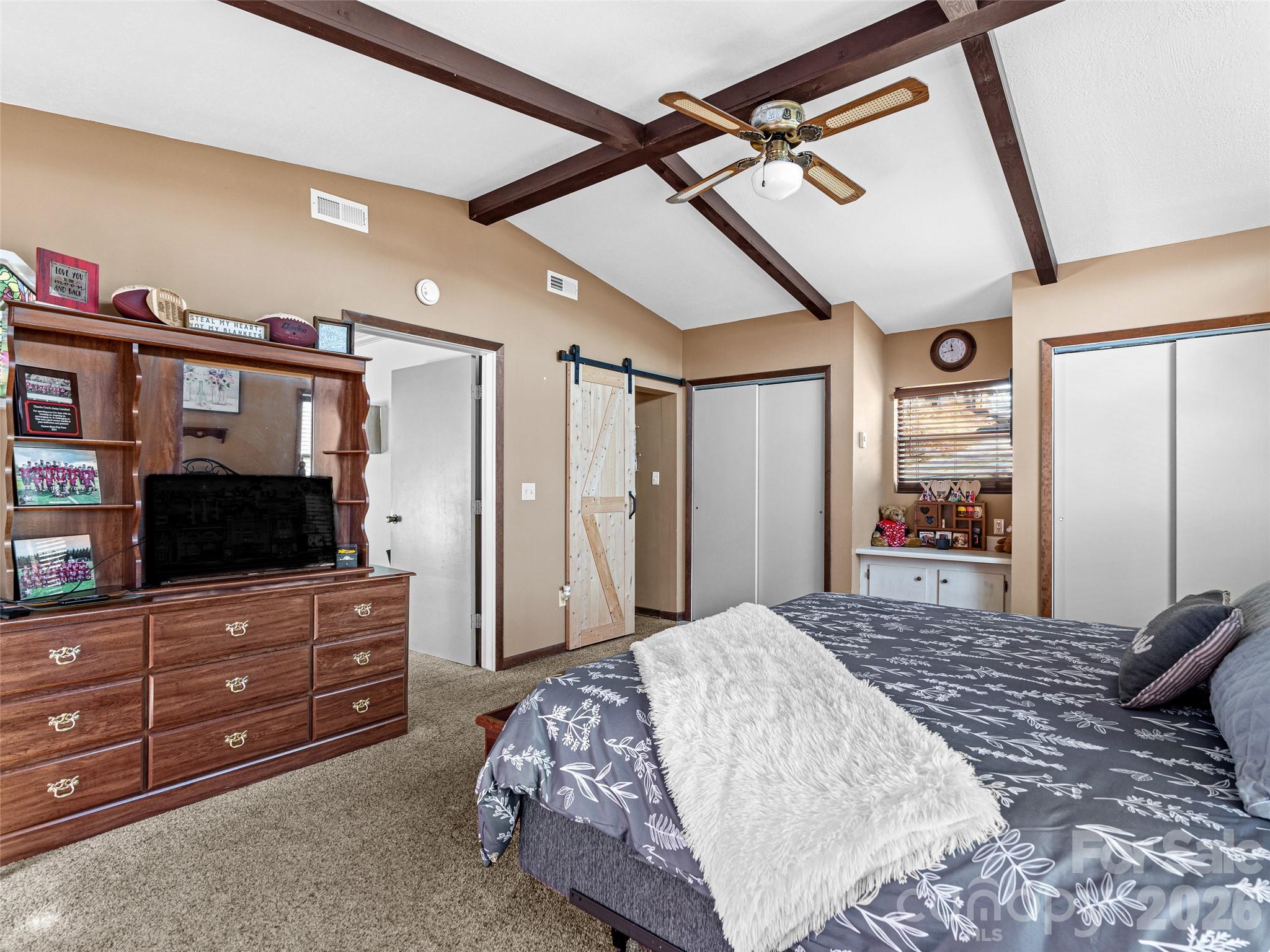 174 Pleasant Ridge Drive Maggie Valley, NC 28751 - Photo 23 of 45 a bedroom with a bed and a flat screen tv